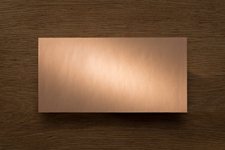 Letter above oak desk in beam of warm lightの写真素材