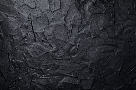 Black or dark gray art plastered wall texture backgroundの写真素材