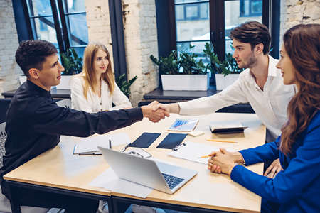 businessmen shaking hands in officeの写真素材