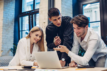 Businesspeople looking on laptop in officeの写真素材