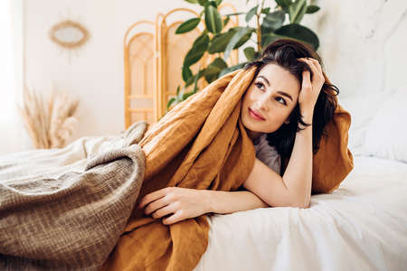 Smiling girl waking up in a farmhouse early in the morningの写真素材