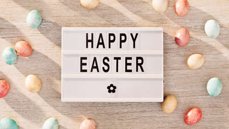 Easter eggs and cinema lightbox with holiday greetingの写真素材