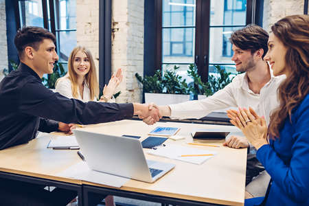 businessmen shaking hands in officeの写真素材
