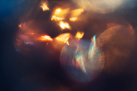 Defocused lens flare sparkling and glowing in the dark
