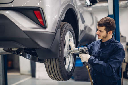 Auto car repair service center. Mechanic at workの写真素材