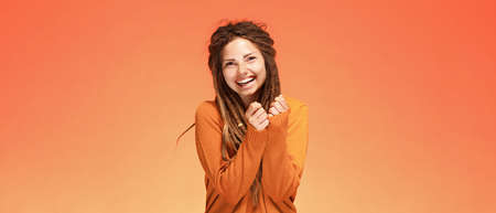 Funny laughing happy young woman with authentic hairstyleの写真素材