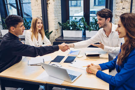 businessmen shaking hands in officeの写真素材