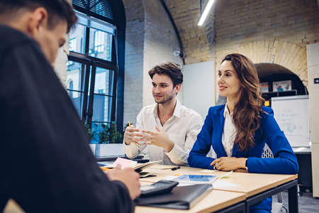 businesspeople discussing at table in officeの写真素材