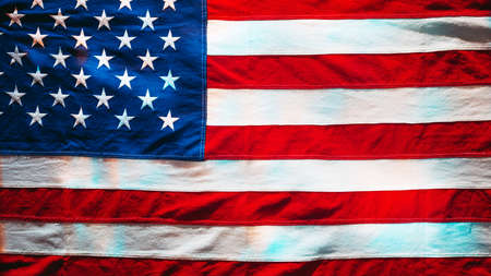 Good old cotton vintage American flag. US flag texture in multicolored lightの写真素材