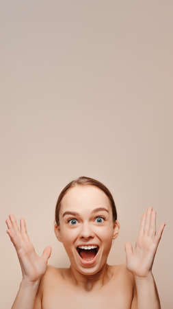 Emotional beauty portrait of very surprised happy young womanの写真素材