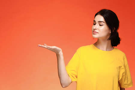 Portrait of young woman looking at her hand mock upの写真素材