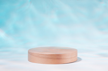 Wooden podium or product stand by swimming pool with reflection of sunlight from waterの写真素材