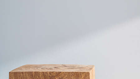 Wooden cubic podium on a white background with shadowの写真素材