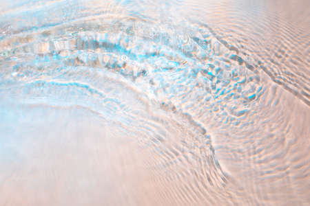 Rainbow colored abstract wavy rippled water texture backgroundの写真素材