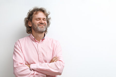 Dreamy and smiling middle aged man portraitの写真素材