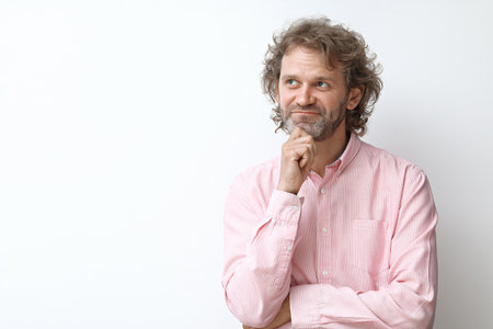Dreamy and happy smiling middle aged man portraitの写真素材