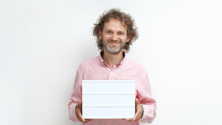 Funny smiling middle-aged man with light box copy spaceの写真素材