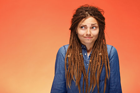 Funny young woman with a confused faceの写真素材