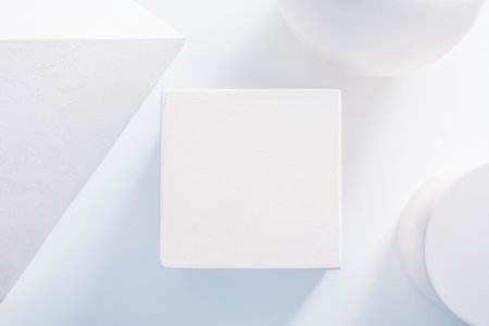 White cubic podium in the middle of gypsum geometric shapesの写真素材