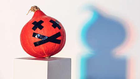 Halloween pumpkin in rainbow light with copy spaceの写真素材