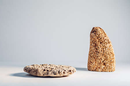 Stone podium with shell rock on a light backgroundの写真素材