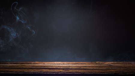 Old wooden platform, podium or table with smoke in the darkの写真素材
