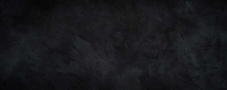 Black or dark gray rough grainy stone texture backgroundの写真素材