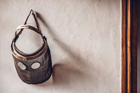 Old vintage protective face mask on the wall. Halloween backgroundの写真素材