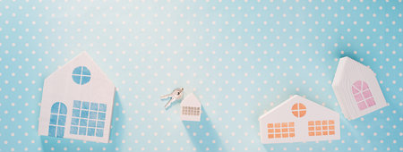 White toy houses on a blue with white polka dot backgroundの写真素材