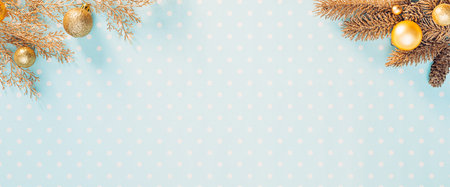 Golden Christmas decorations on a light blue backgroundの写真素材