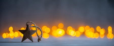 Decorative wooden Christmas star on the background of bokeh lightsの写真素材