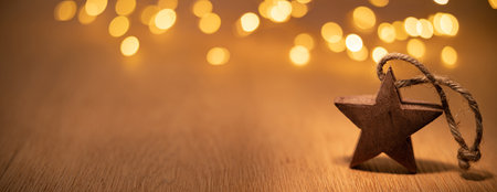Decorative wooden Christmas star on the background of bokeh lightsの写真素材