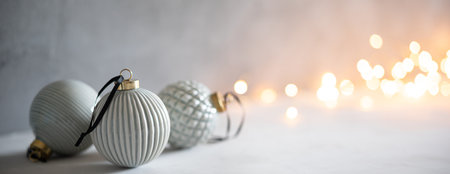 Scandinavian style pastel colored baubles with Christmas bokeh lightsの写真素材