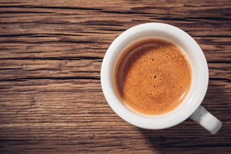 Small cup of espresso coffee crema on woodの写真素材