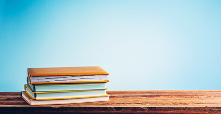 A stack of books and notebooks on desk or shelf. Education, studying and back to school conceptの写真素材