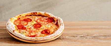 Homemade pepperoni pizza with salami sausage and hamの写真素材