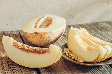 Sliced melon on wooden tableの写真素材