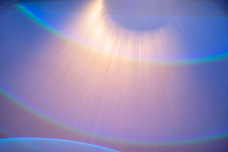 Dramatic light rays casting vibrant rainbow colors in a tranquil atmosphere. The diffusion creates an ethereal effect, inviting peaceful reflection.の写真素材