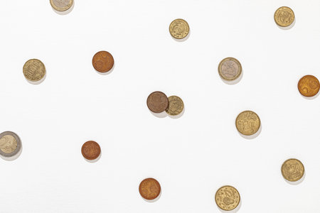 European coins scattered on a white textured background showcasing different value.の写真素材