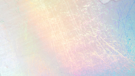 Scratched foil texture with iridescent hues creating a subtle, colorful background.の写真素材