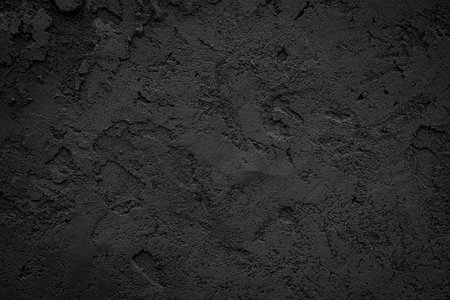Black or dark gray rough grainy stone or sand plaster texture background.の写真素材