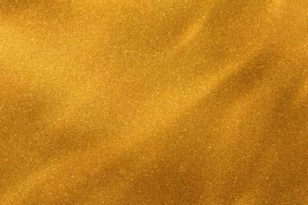 Golden glitter texture creates a shimmering and radiant background for decoration or artistic projects.の写真素材