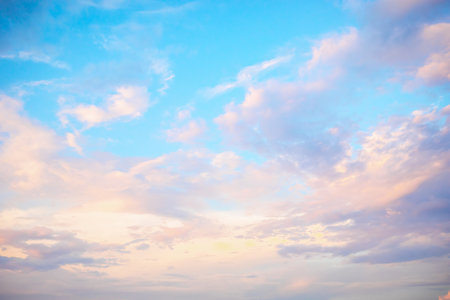 Colorful clouds fill the sky as the sun sets, casting a gentle light. The tranquil atmosphere invites reflection and appreciation of natures beauty.の写真素材