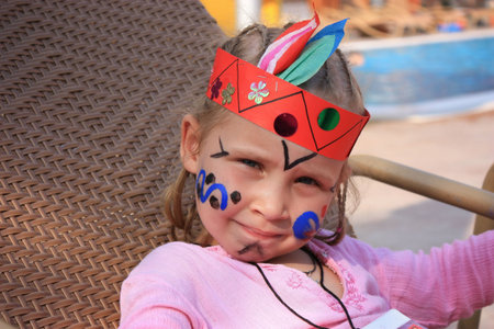 Child dressed as an indian with a face painted