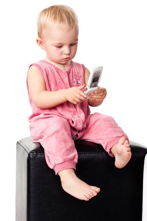 Baby talking on the mobile phone isolated on whiteの写真素材