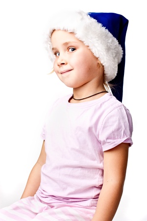 Girl in Santa'sblue hat isolated on whiteの写真素材