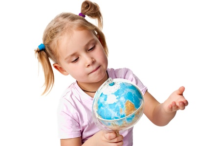 Beautiful girl playing with a globe, pointing a continentの写真素材