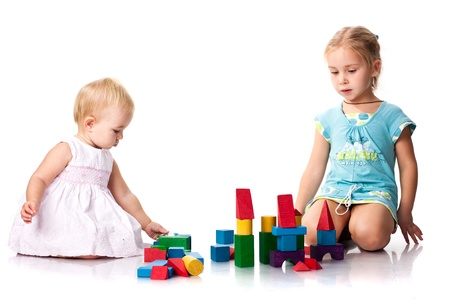 Children building a castle with cubes isolated on whiteの写真素材