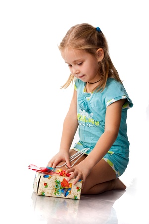 Beautiful girl with a present isolated on whiteの写真素材