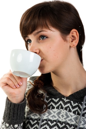 Beautiful girl holding a cup of tea isolated on whiteの写真素材